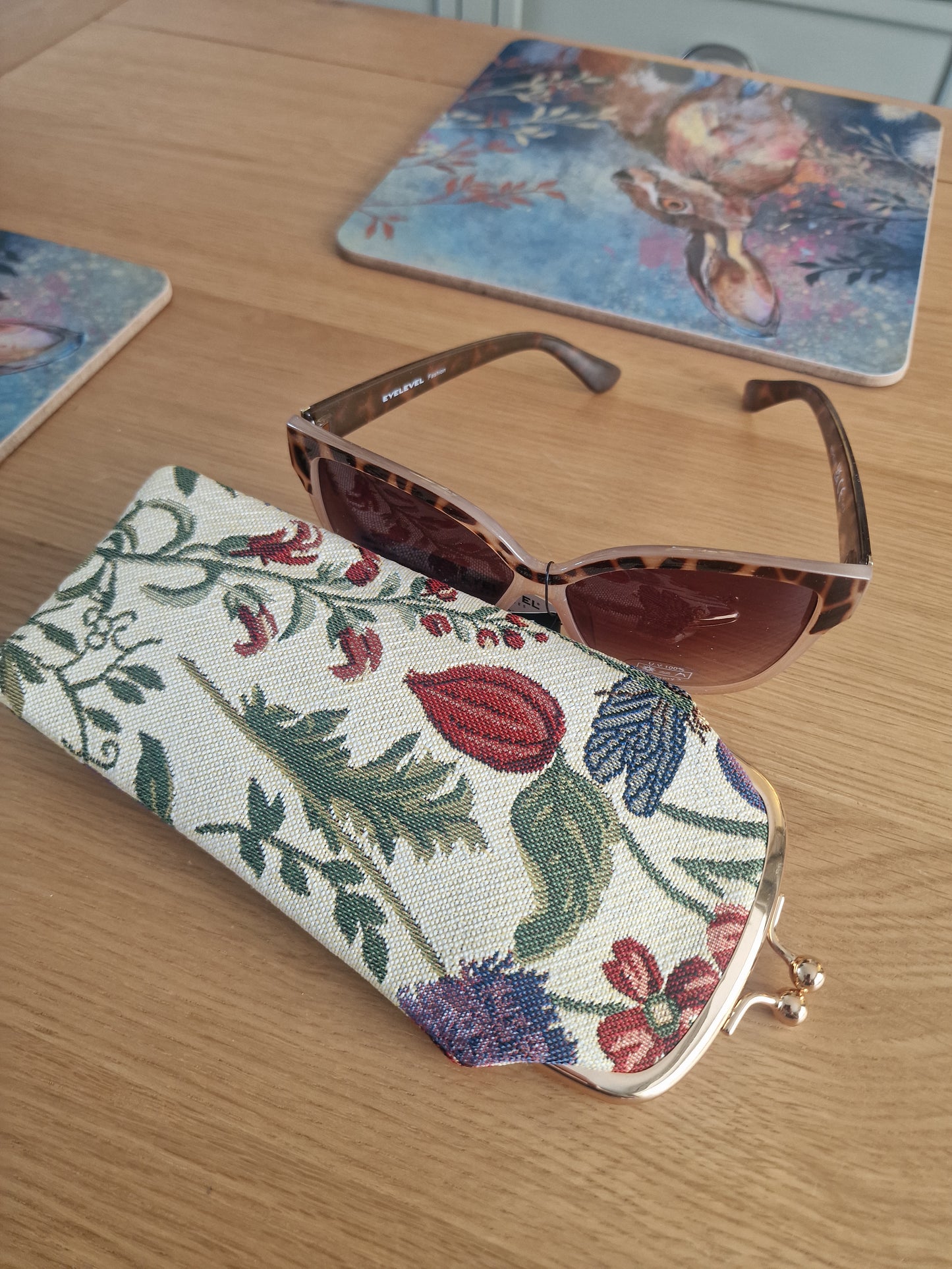 Morning Garden Design - Glasses purse in cream woven fabric with colourful floral and leafy botanical pattern plus metal clasp shown with brown tinted glasses